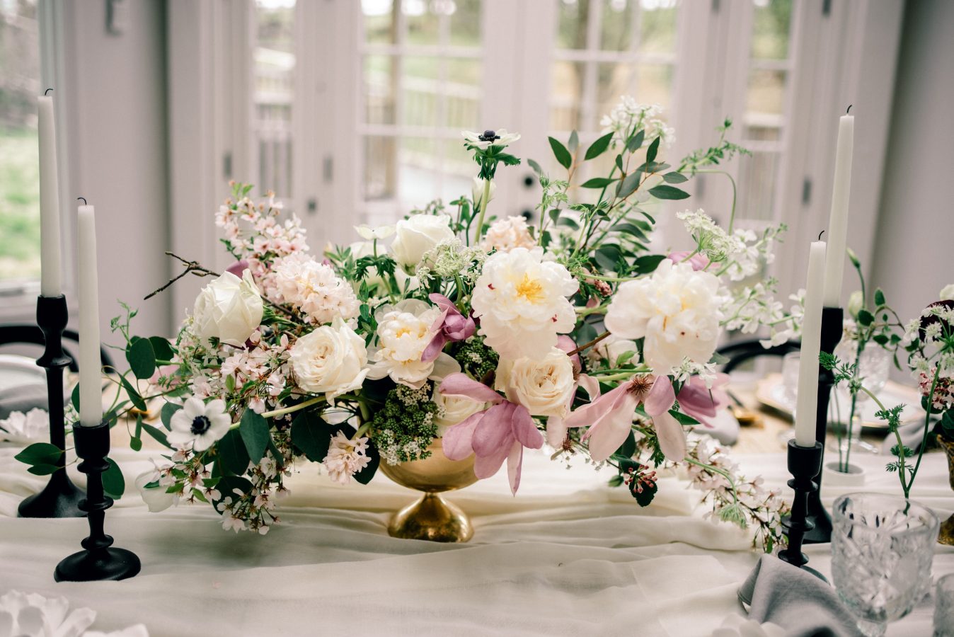 Image of a lovely floral arrangement placed on a tablescape designed by FRENCH | DOOR EVENTS