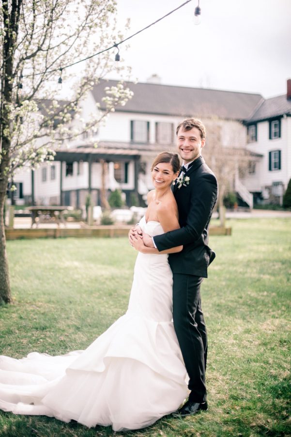 Image of a wedding couple embracing in the Virginia countryside