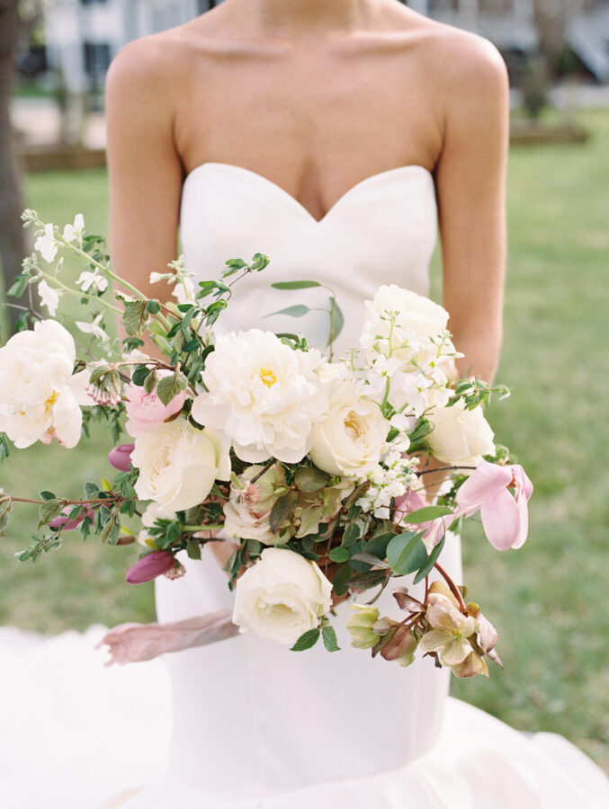 Image of a bride with a beautiful bouquet of white flowers.